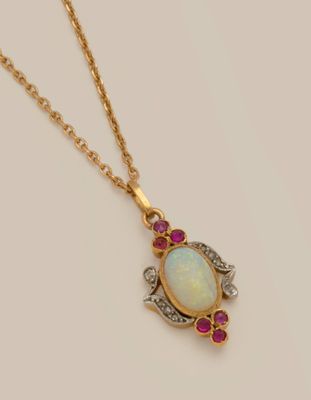 an oplite and ruby pendant on a gold chain