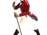 figurine of a man in a red coat and hat holding a cane