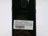 the back of a black samsung s9 with a white sticker on it