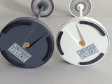 two clocks that are sitting on a table