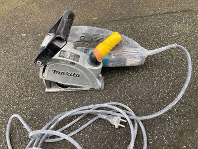 a cord and a tool on the ground next to a cord cutter