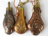three bottles hanging from a rope on a wall