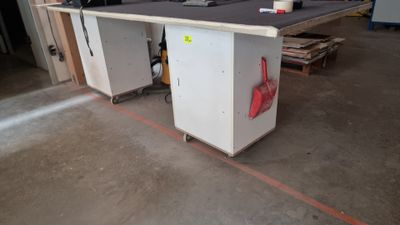 a picture of a workbench in a warehouse with a lot of work on it