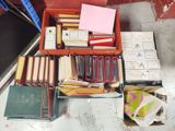 a box full of books and papers sitting on a table