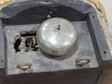 a silver bell sitting on top of a wooden box