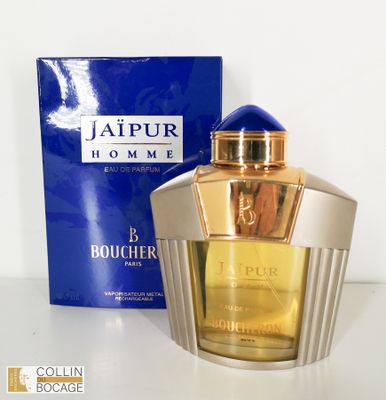l'image d'un flacon de parfum posé à côté d'une boîte
