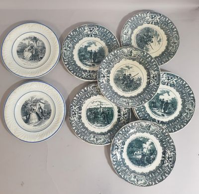 several plates with blue and white designs are arranged on a table