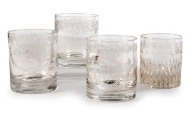 four clear glass tumbles sitting next to each other on a white surface