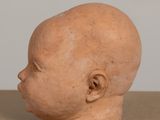 a clay head of a baby on a table