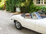 a white sports car parked in front of a house