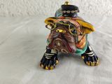 a small figurine of a dog wearing a hat