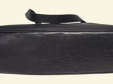 black leather toilet bag on a white background with a black strap