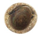 an old metal bowl with a rusted surface on a white surface