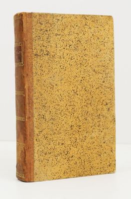 an old book sitting on top of a white surface