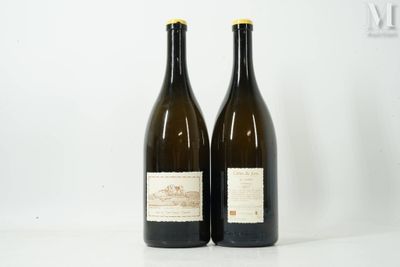 two bottles of wine sitting on top of a table next to each other