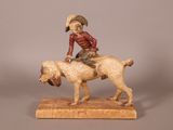 statue représentant un garçon à cheval accompagné d'un chien, posée sur un socle