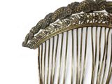 a gold comb with a bird on it on a white background