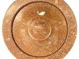 a brown plate with a bird on it on a white surface