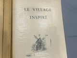 an open book with a drawing of a windmill on the cover