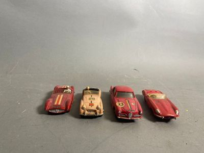 four toy cars are lined up in a row on a table