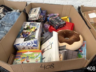 une boîte en carton remplie de jouets et de jeux, posée par terre