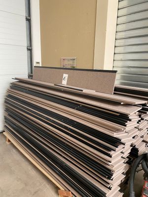 a pile of cardboard sitting on a pallet in front of a garage door