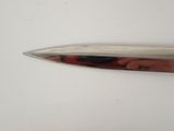 a knife that is laying on a white surface