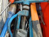 many different tools in a red bin with a blue handle