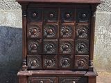 an old wooden chest with many drawers and drawers on top of it