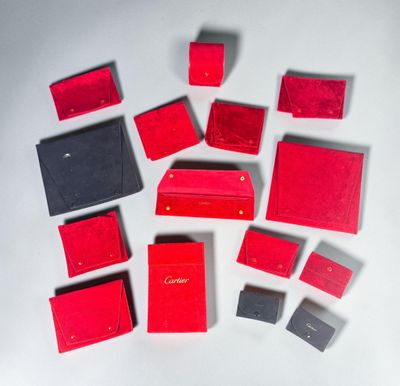 many red and black wallets on a white surface