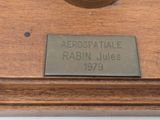 a clock that is sitting on top of a wooden table