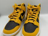 a pair of yellow and black sneakers on a white surface