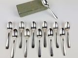six spoons and a spoon rest on a table