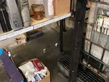 a metal rack with many items on it in a garage