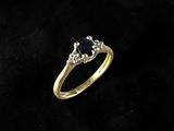 a gold ring with a sapphire stone and diamonds