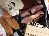 many pairs of shoes that are sitting in a pile