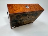 a small wooden box with a metal latch on it