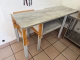 a kitchen with a table and a stove in it