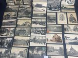 a lot of old black and white pictures on the table