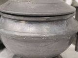 many pots and pans that are sitting on a table
