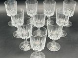 six clear wine glasses sitting on top of a table next to each other