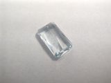 a close up of an aquamarine stone on a white surface