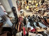 many pairs of shoes sitting on a table in a room