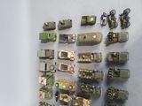 a lot of toy army vehicles on display on the wall