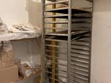 a metal rack with trays of food on it in a room