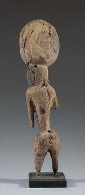 an image of a wooden sculpture of a woman with a hat on her head