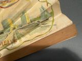 an old book with a picture of a city on it