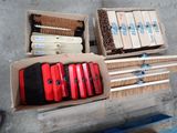 boxes of brooms and brushes are sitting on a concrete floor