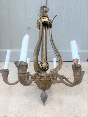 a chandelier that has five candles on it
