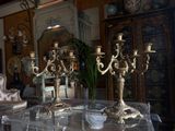 a table with three candles on it in the middle of a room